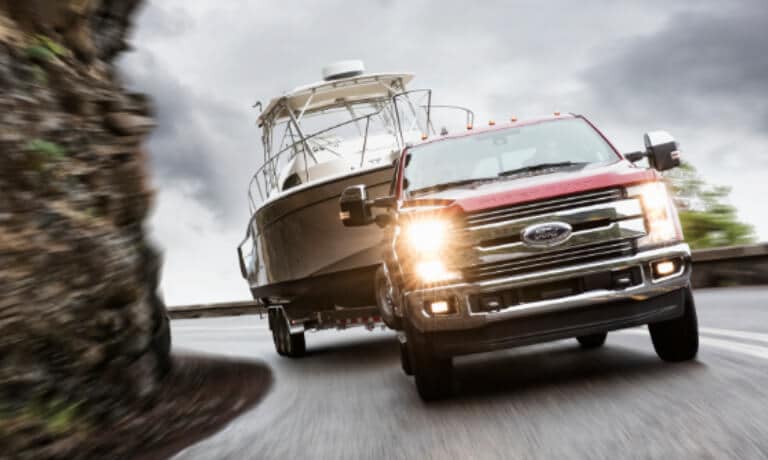 2019 Ford Super Duty towing boat along cliff