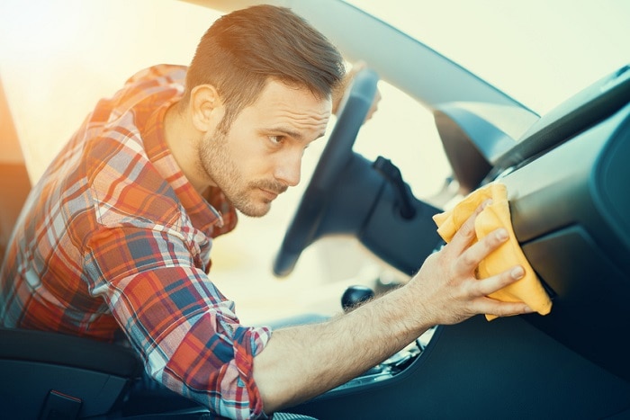 Man_Cleaning_Dashboard_Of_Car.jpg