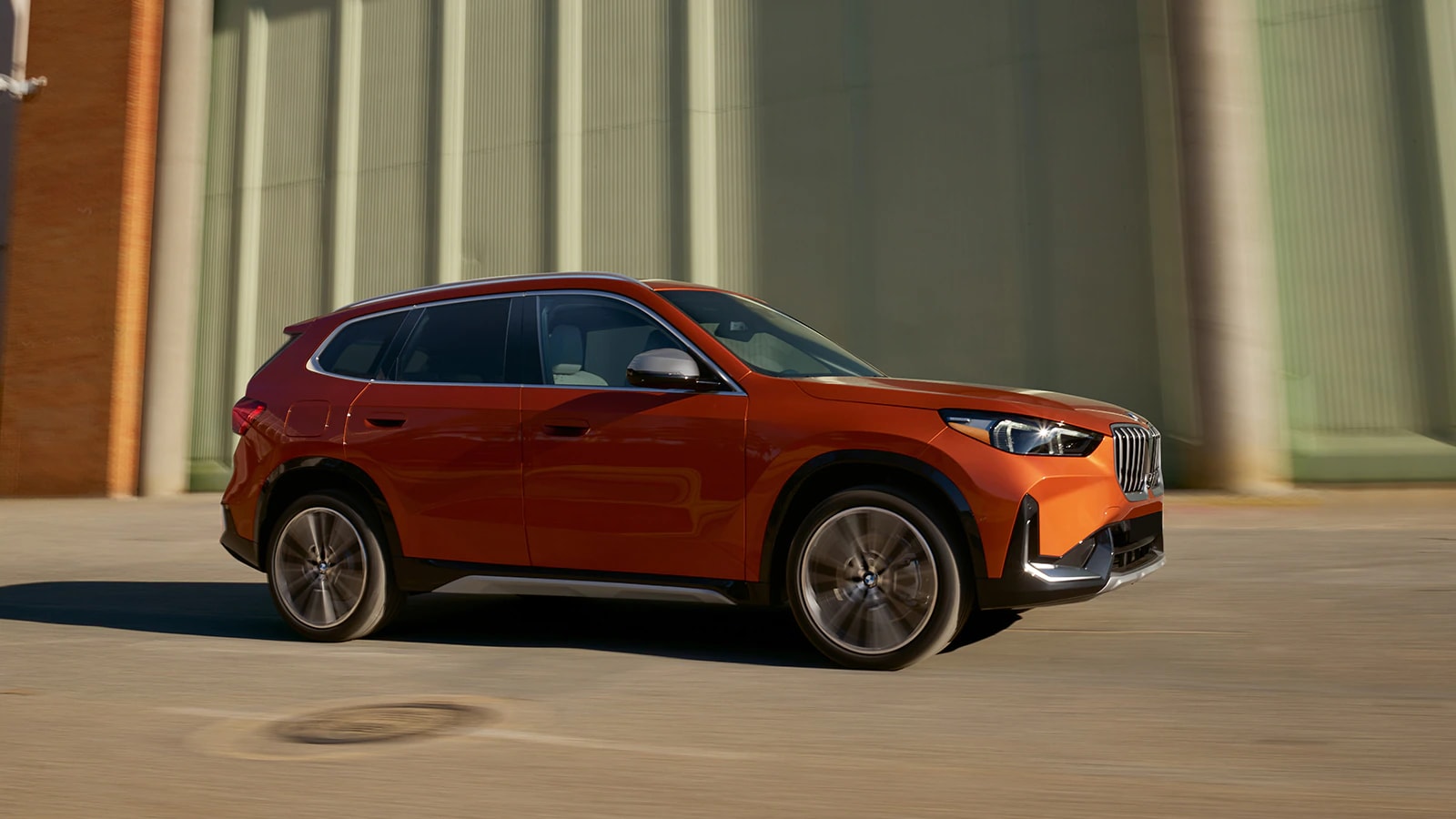 Orange BMW X1 parked in profile