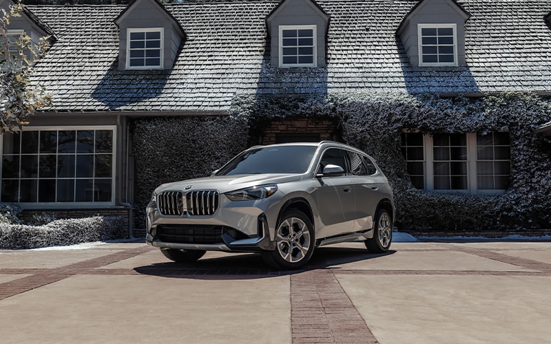  BMW X1 series parked next to a house.