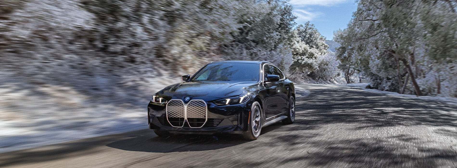  BMW i4 series driving on a road.