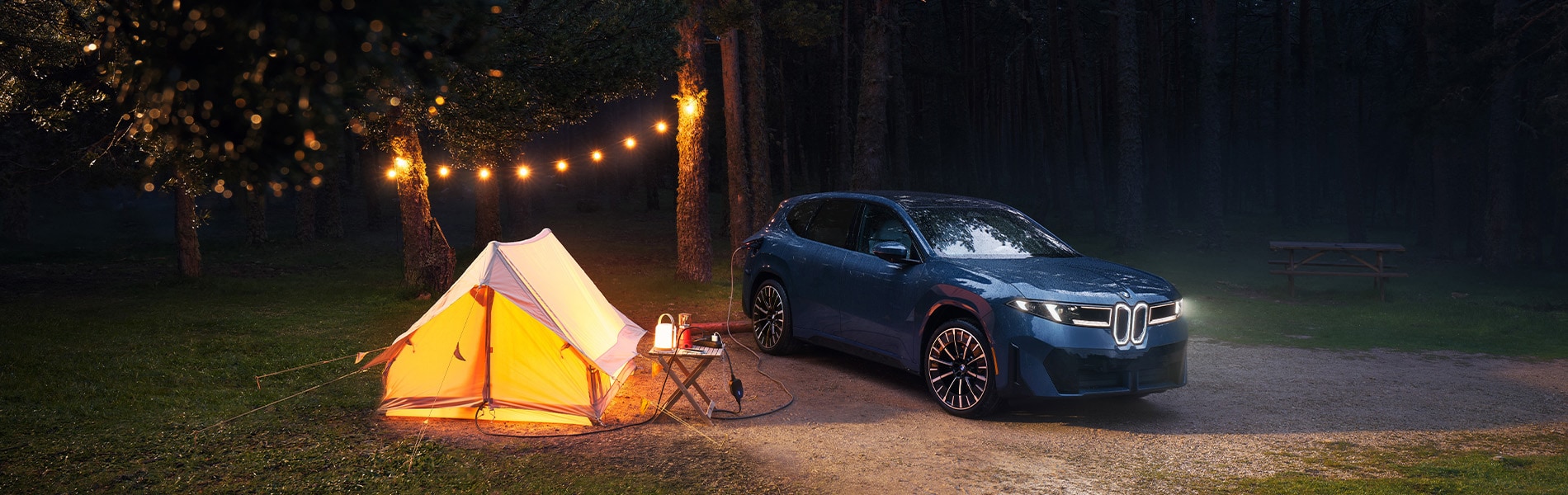  Parked BMW iX3 powering campsite.