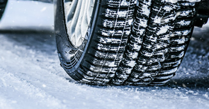 Close-up of a winter tire on a snowy road