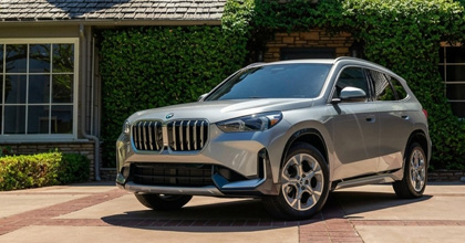 Silver BMW SUV parked in a sunny driveway