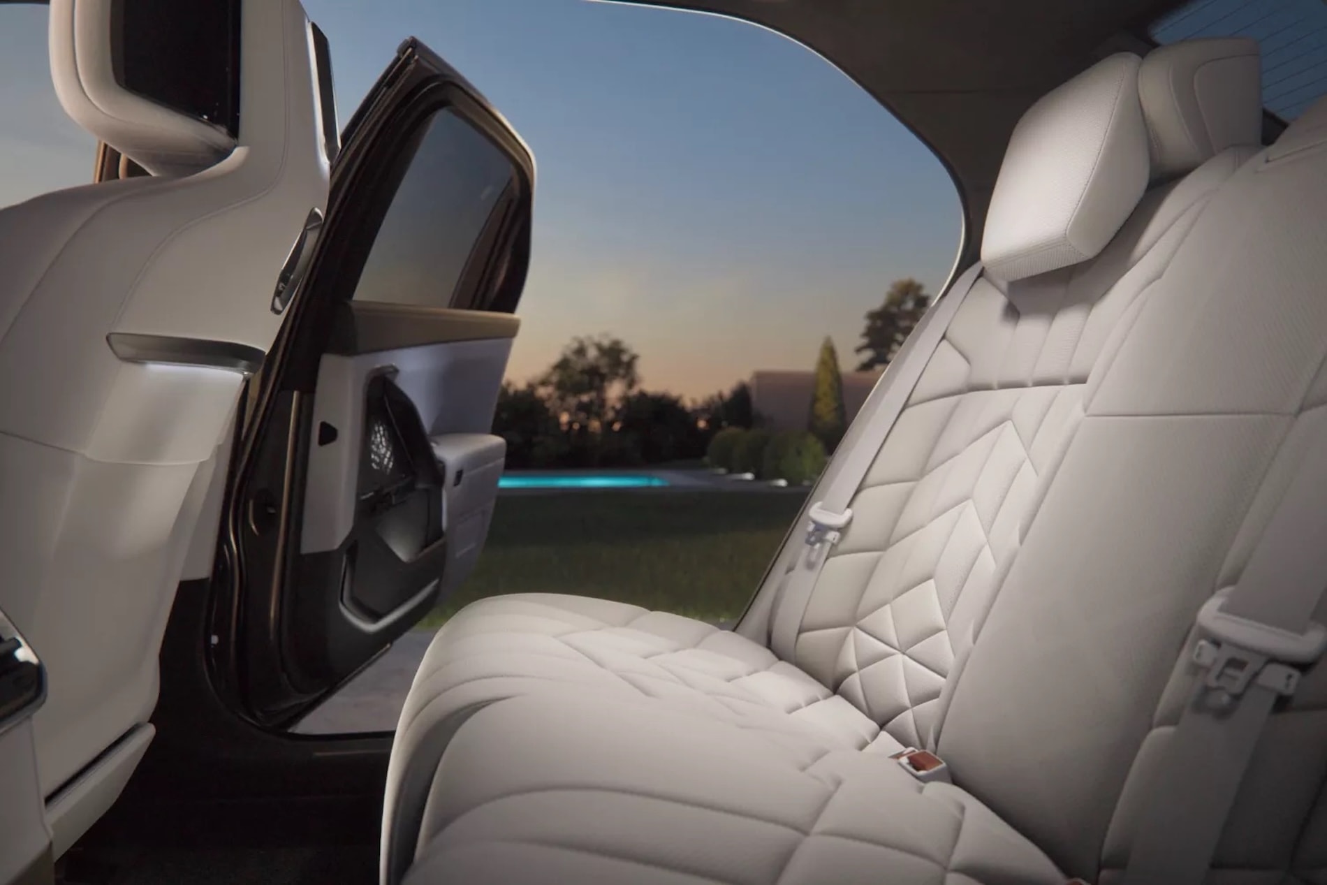 2027 BMW 7 Series Sedan interior, rear seat with the door open at dusk