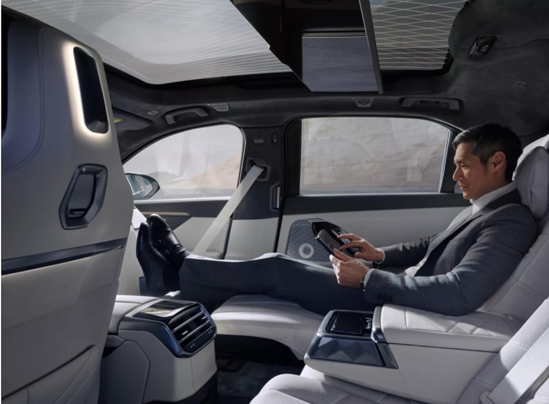 2027 BMW 7 Series Sedan interior, rear passenger reclined with the footrest extended