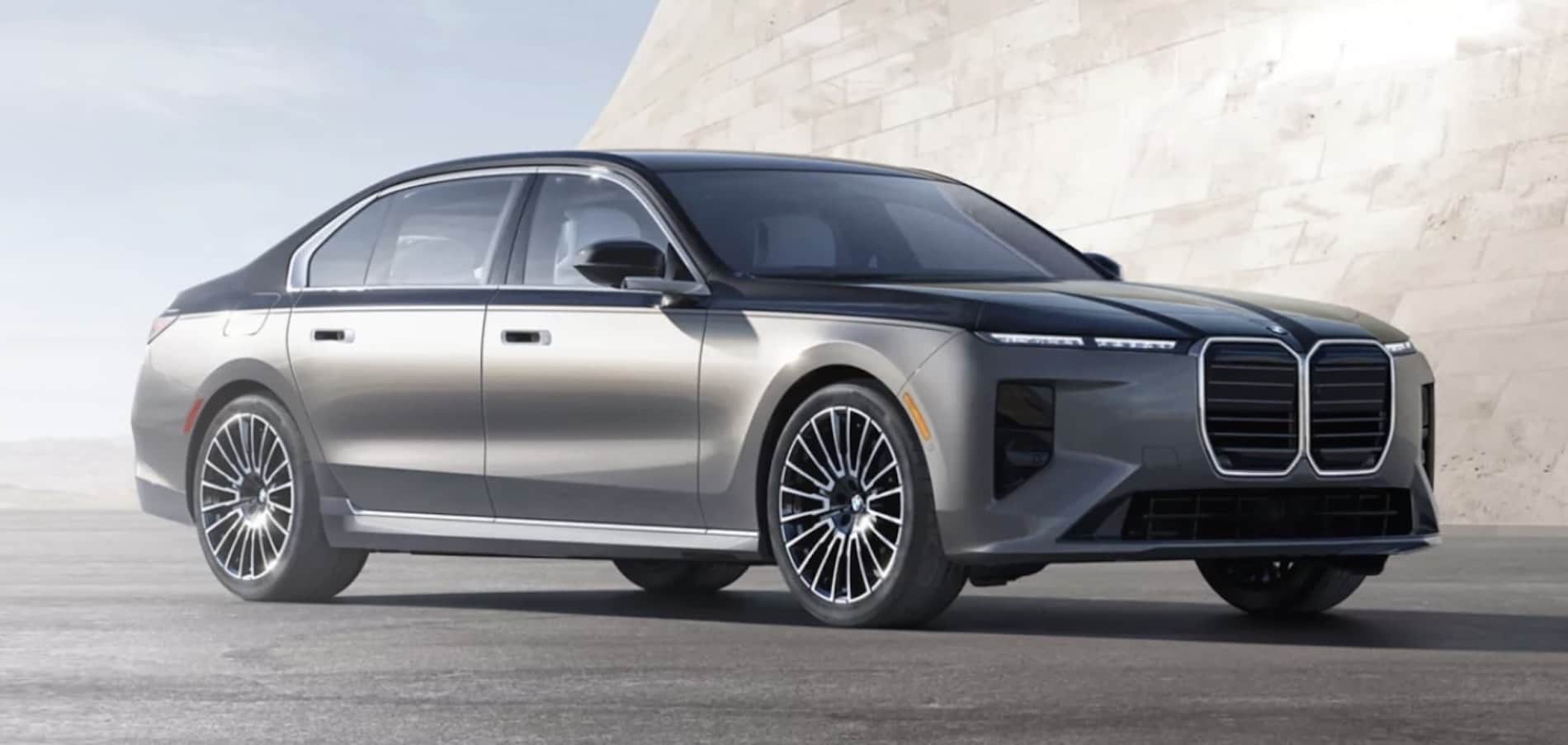 2027 BMW 7 Series Sedan exterior in silver with a dark roof, front three-quarter view