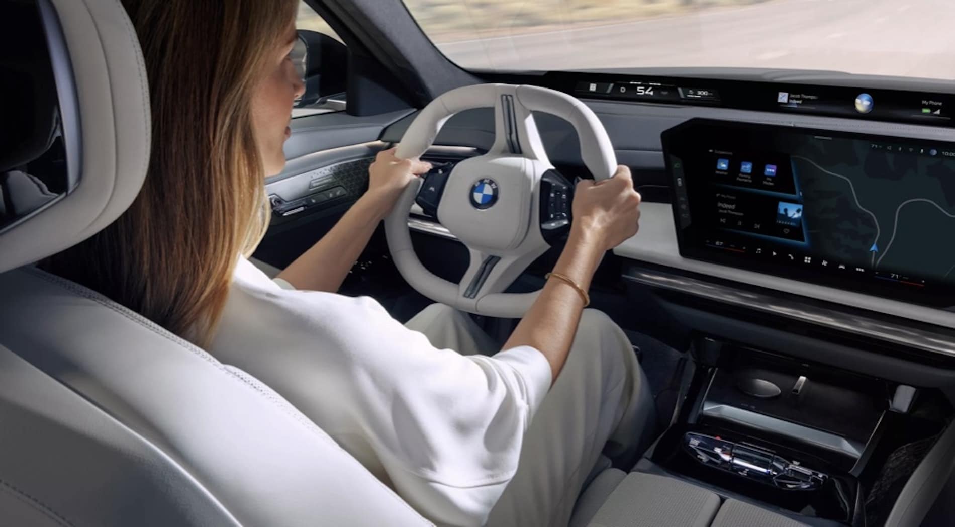 2027 BMW 7 Series Sedan interior, driver's view of the steering wheel and curved display