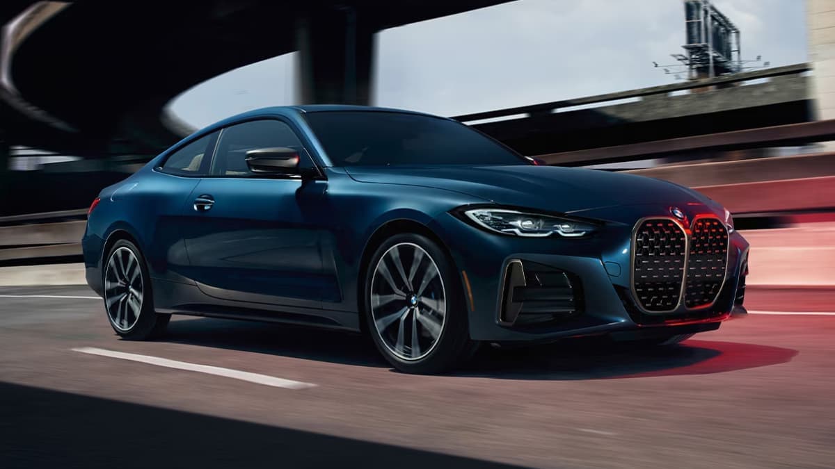 2024 BMW 4 Series driving down a road