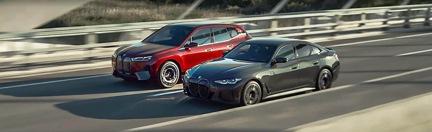 Two BMW electric vehicles driving on a bridge