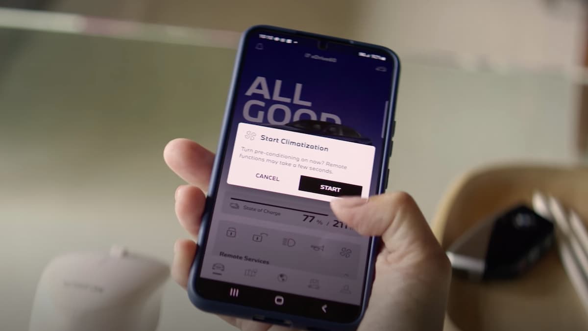 Person starting BMW preconditioning on their smartphone