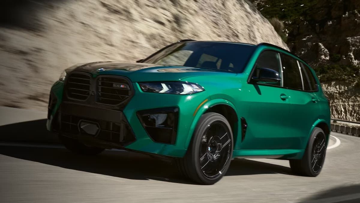 A 2024 BMW X5 M driving down a road