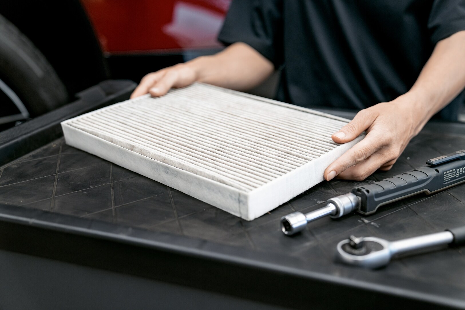 closeup of BMW service technician holding replacement air filter