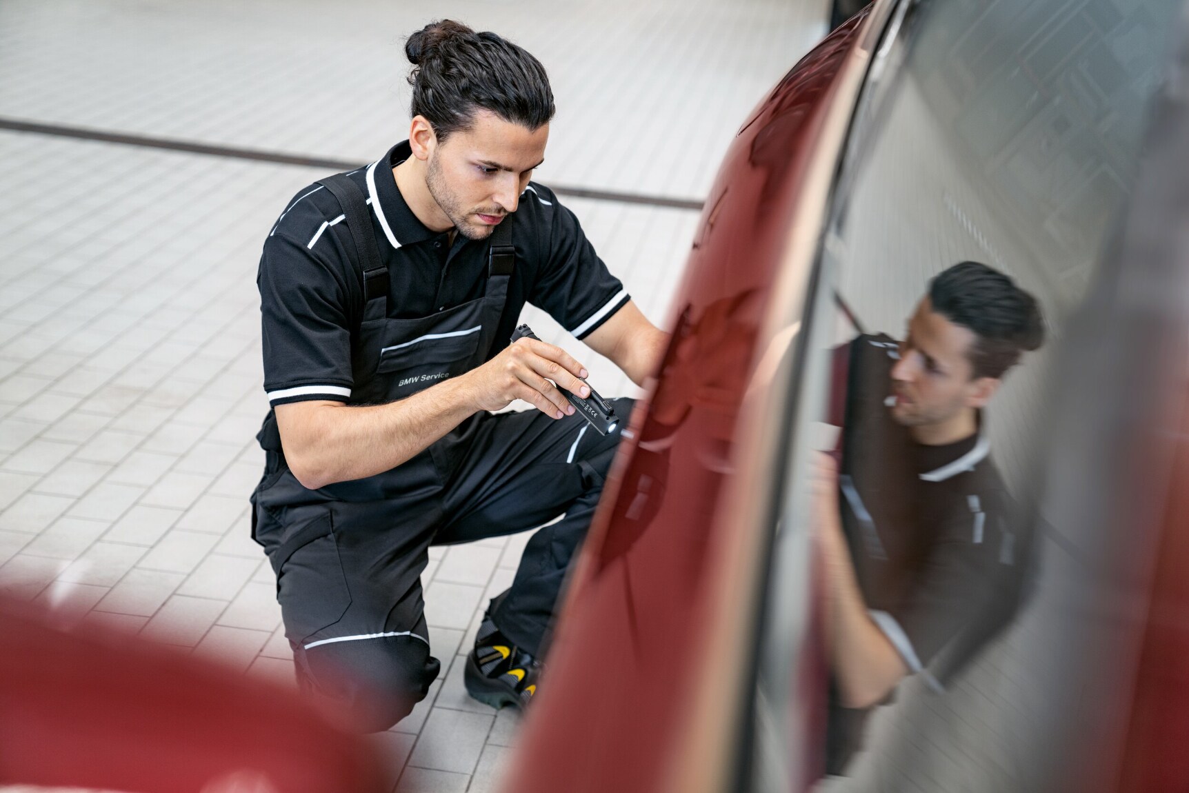BMW service technician working on vehicle