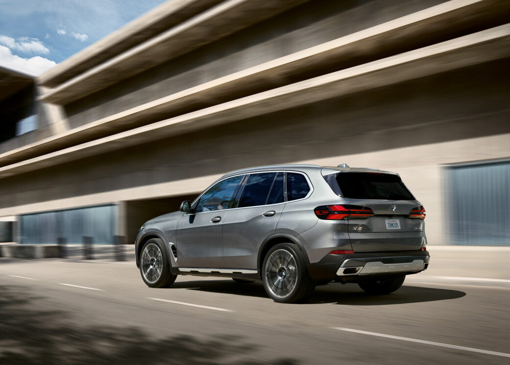 2024 BMW X5 driving down the road.jpg