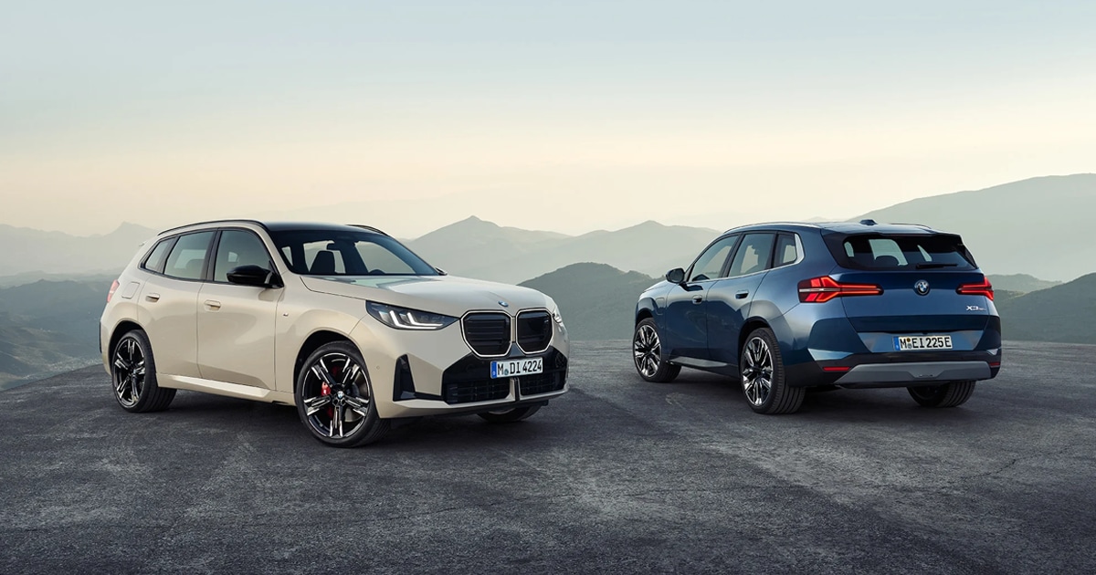 2 BMW X3 vehicles in white and in blue parked on display in the mountains.