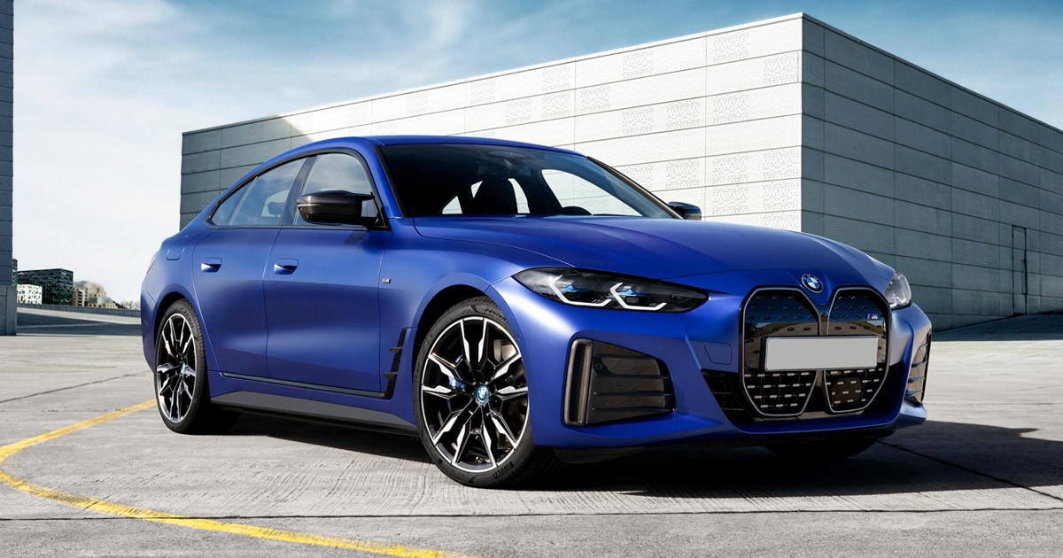 2024 BMW i4 in frozen Portimao blue metallic color parked in a parking lot