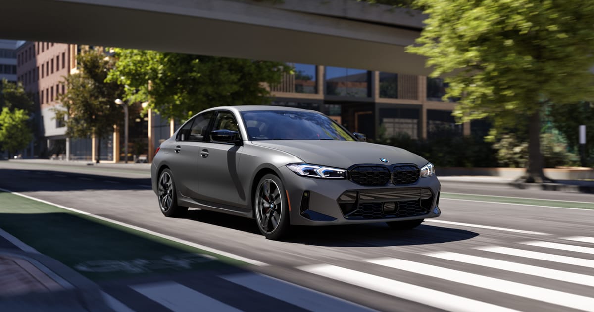 BMW M340i xDrive Sedan driving in a city.