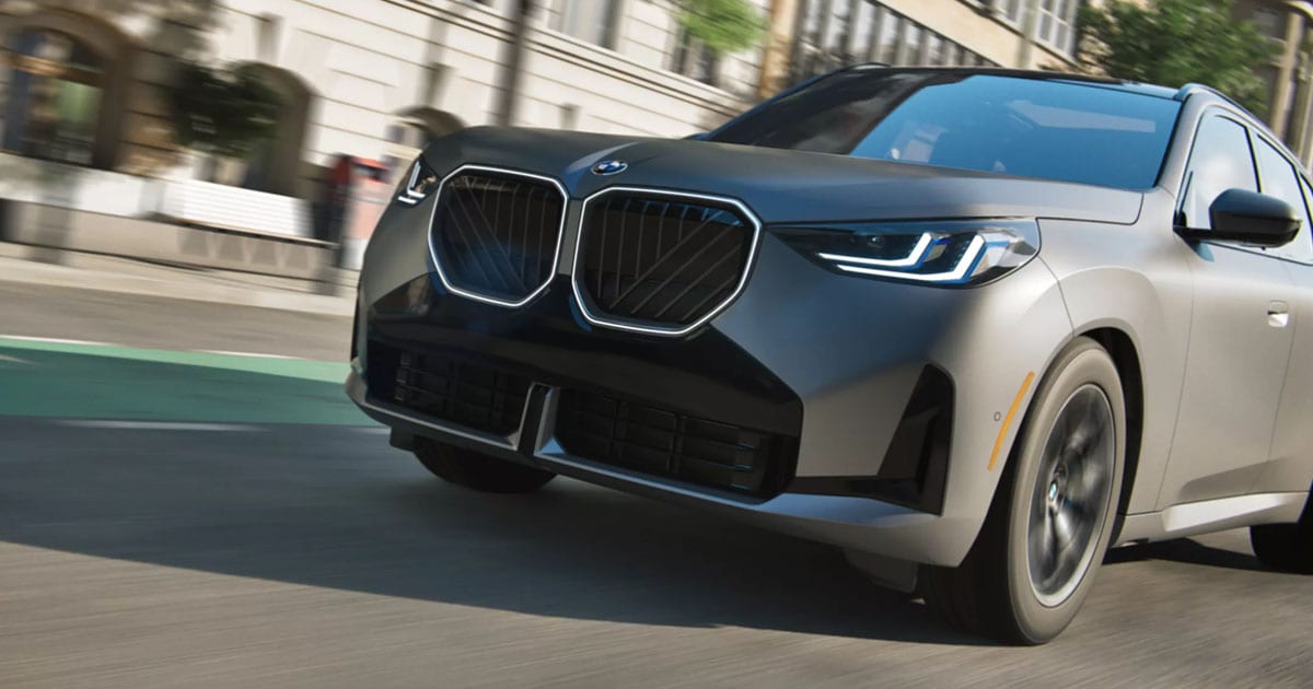 2025 BMW x3 driving through a city street.