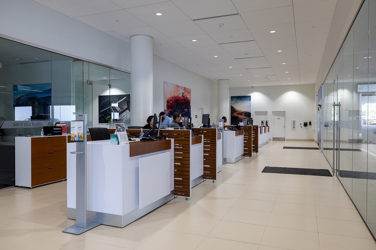Interior view of BMW of Rockville, featuring several bays of desks