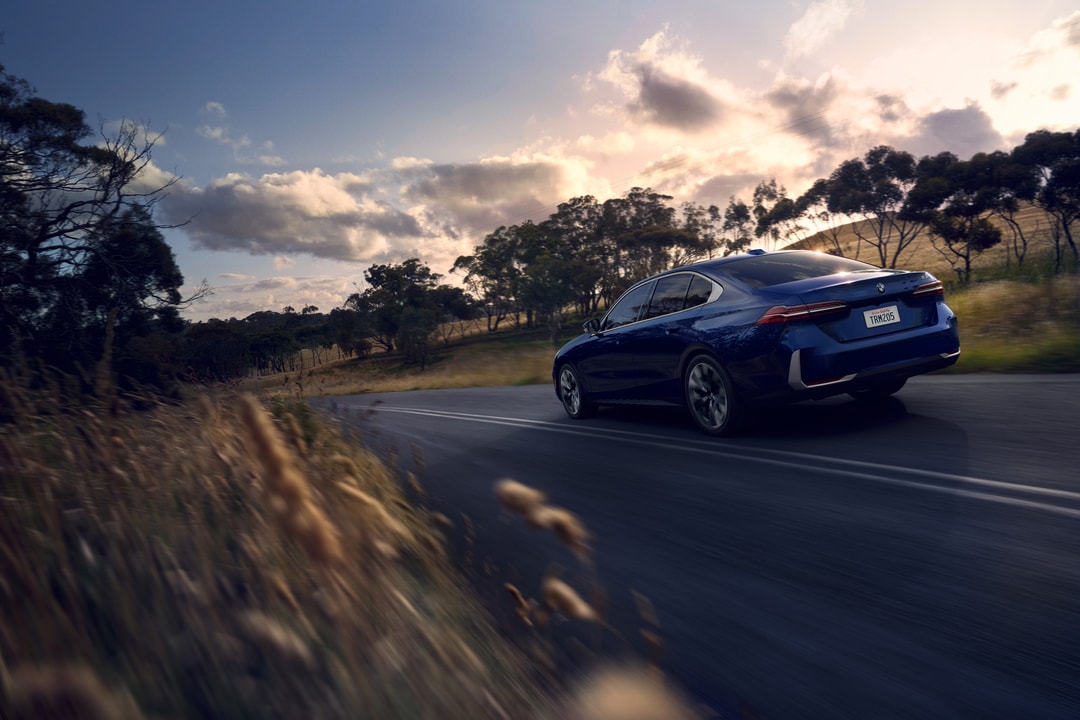 BMW 530i on the road at sunset