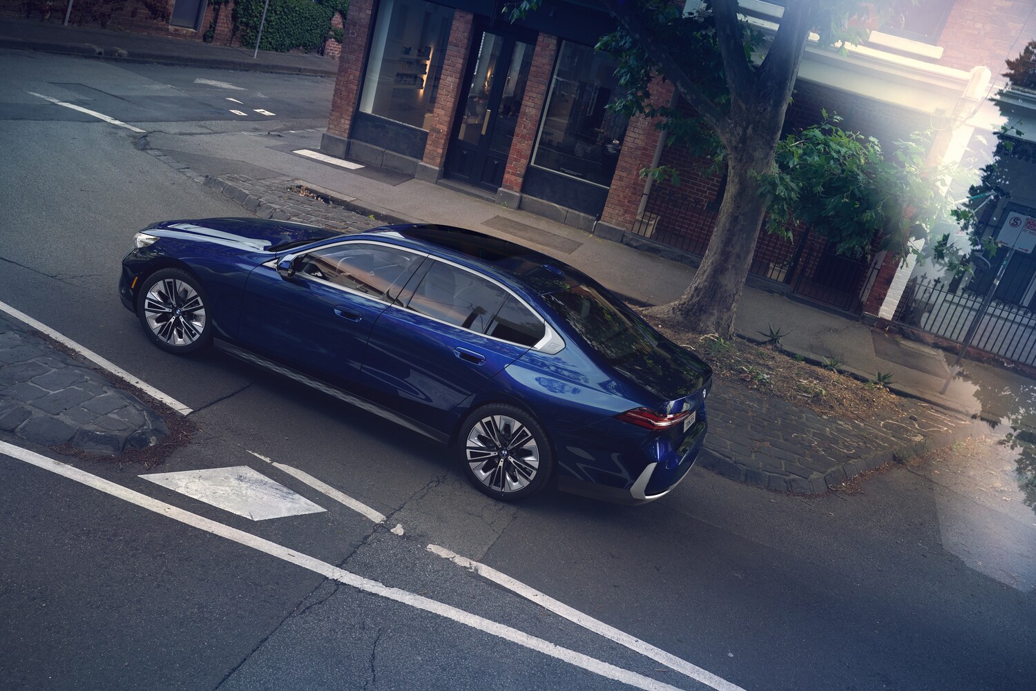 2025 BMW 5 series driving on city road