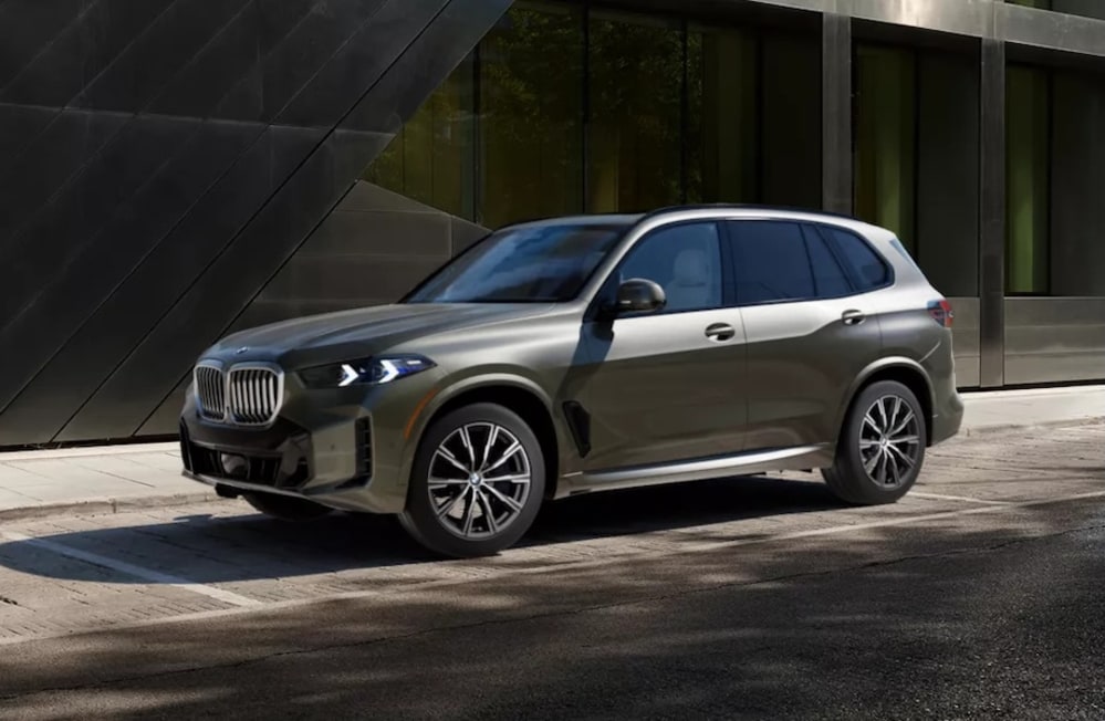 A side view of a beige 2026 BMW X5 SUV
