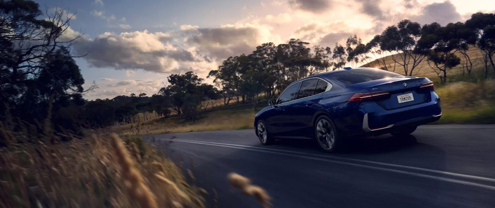 2026 BMW 5 Series driving through the country side