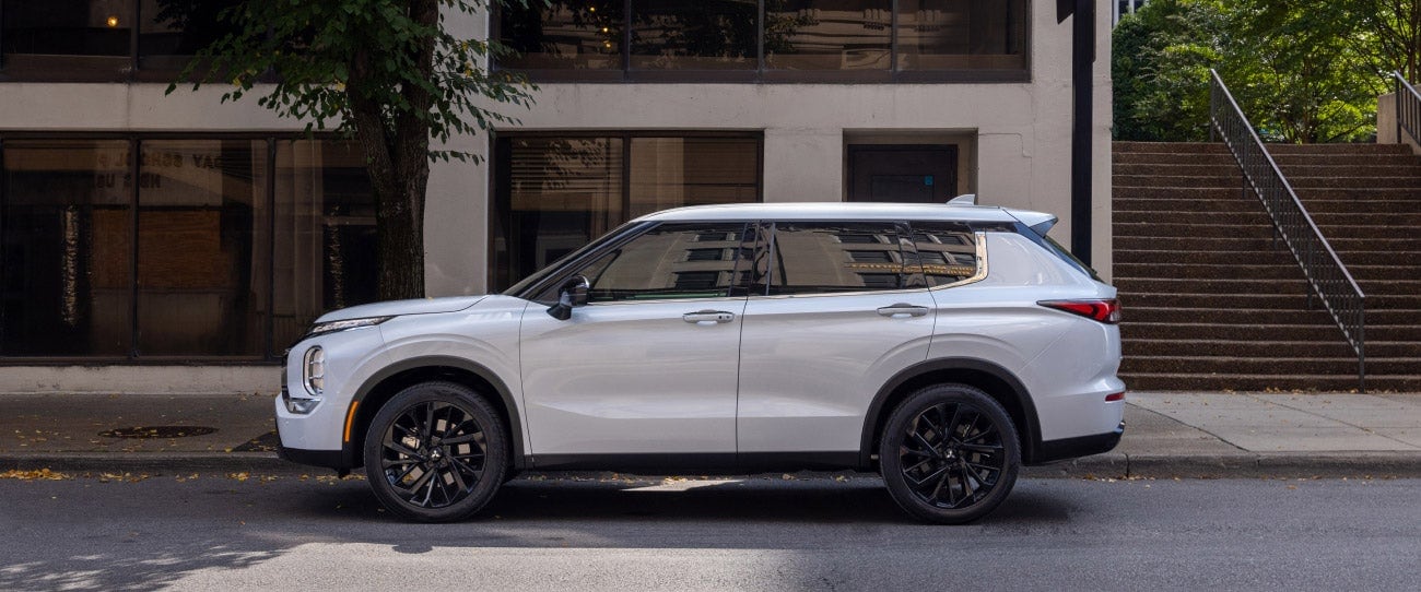 2024-mitsubishi-outlander-suv-white-side-profile-parked.jpg