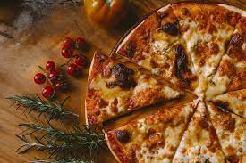 cheese pizza on a wood serving platter