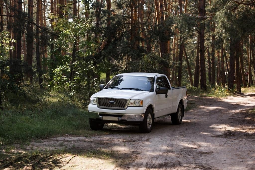 White truck on a trail in a forest.jpg