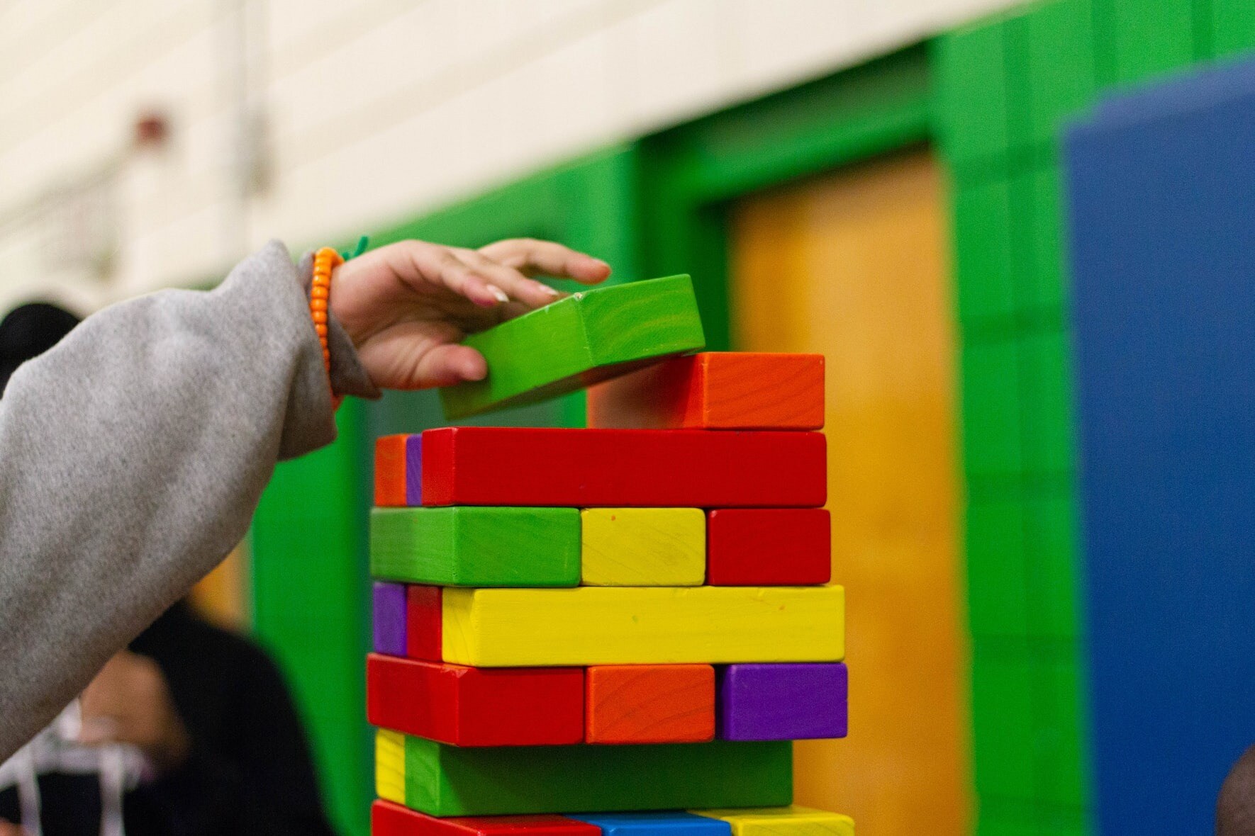 Child piling up building blocks into a stack.jpeg