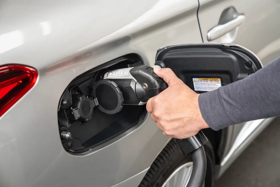 Hand%20plugging%20charging%20cable%20into%20an%20electric%20vehicle.png