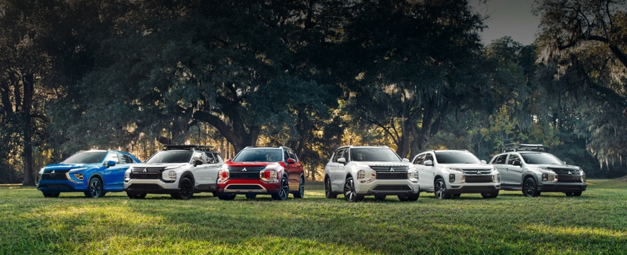 Mitsubishi%20SUV%20lineup%20parked%20on%20grassy%20field.png