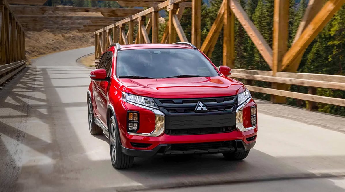 Front%20view%20of%20a%20red%20Mitsubishi%20car%20on%20the%20road.png