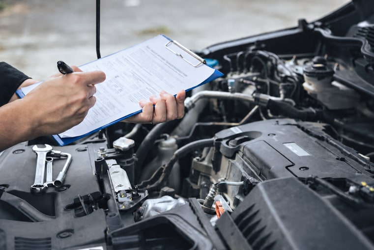 Technician%20completing%20vehicle%20maintenance%20checklist%20during%20engine%20inspection.png