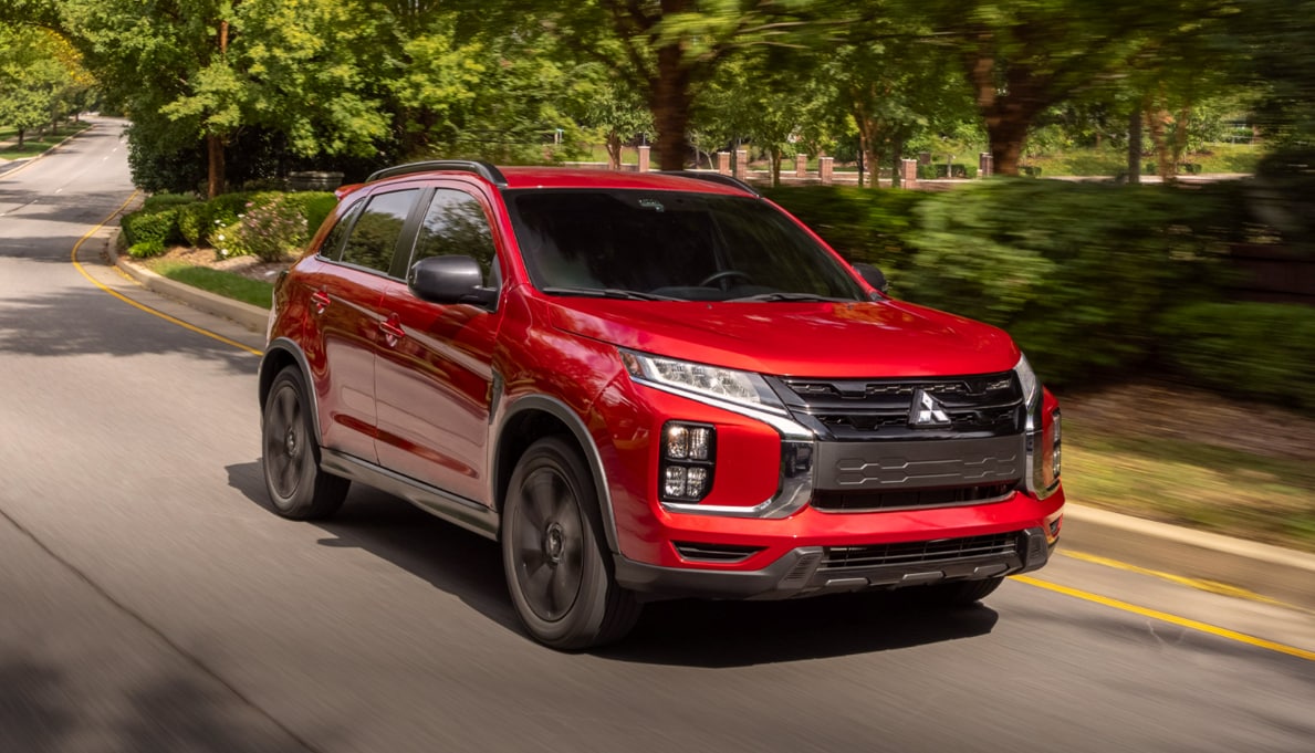 Red%20Mitsubishi%20Outlander%20Sport%20driving%20on%20a%20road.png