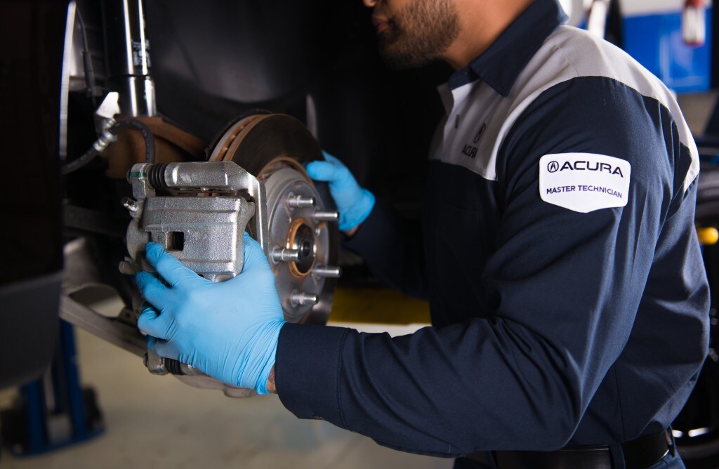 3 Main Benefits of Using OEM parts for your vehicle at Bobby Rahal Acura of Mechanicsburg | Acura service technician putting new brakes on a vehicle