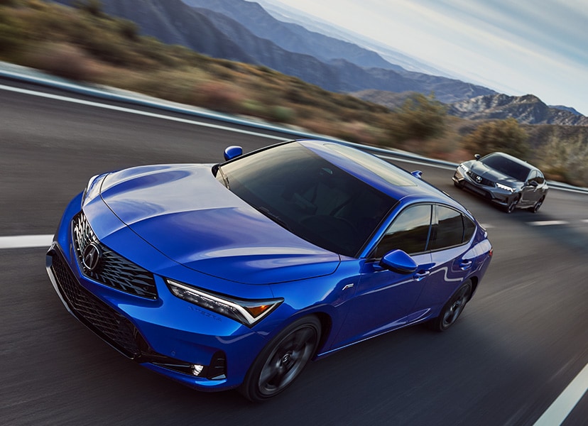 All-New 2023 Acura Integra at Bobby Rahal Acura | Blue & Silver 2023 Acura Integra Driving Fast Down Road with Mountains in Background