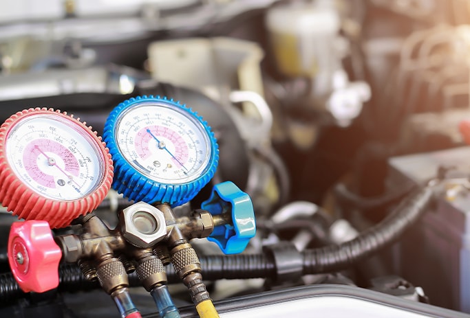 How to Get Your Car Summer Ready at Bobby Rahal Acura in Mechanicsburg, PA | A/C charger connected to A/C outlets in engine bay