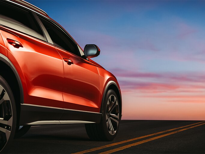 What is Paintless Dent Repair? | Bobby Rahal Acura | Red SUV parked on a main road with the sunset in the background
