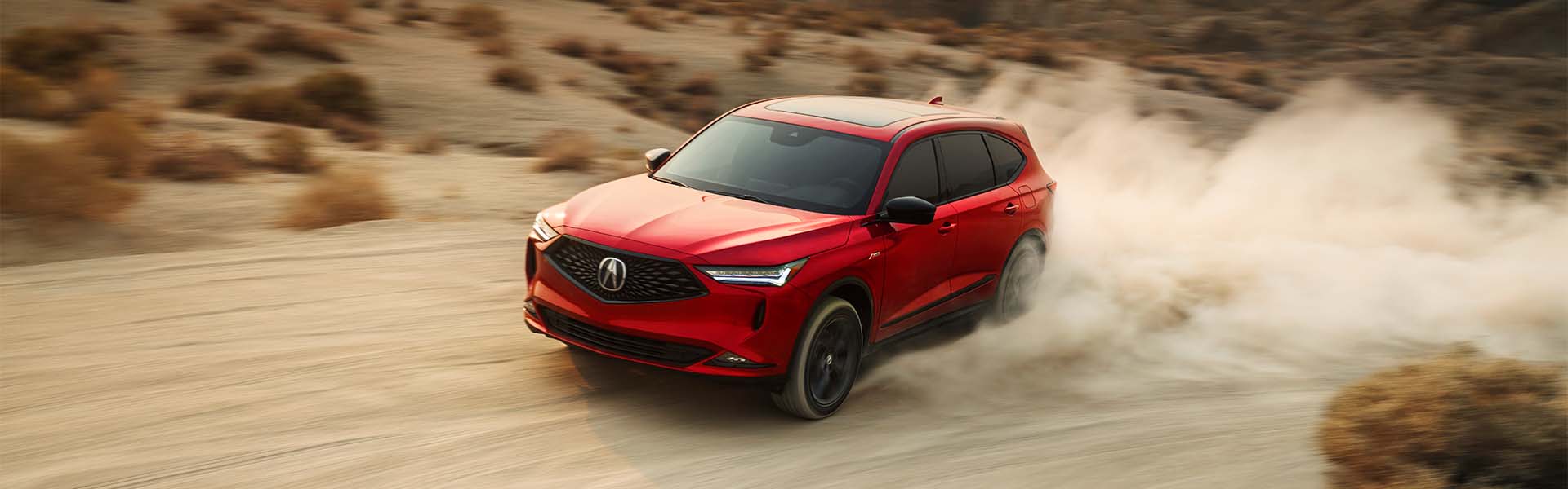 Model Features of the 2022 Acura MDX at Bobby Rahal Acura | Red 2022 Acura MDX Driving Fast Through Desert, Kicking Sand Up Behind it