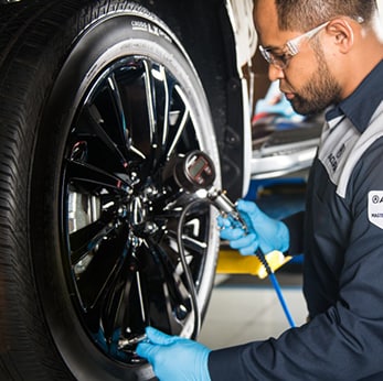 How to prepare your Acura for the winter season in Mechanicsburg, PA at Bobby Rahal Acura | Close-up of Bobby Rahal Aura Technician testing tire pressure on tires