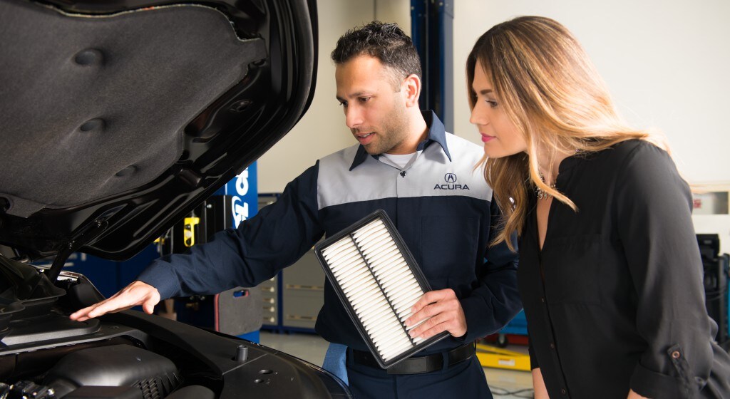3 Main Benefits of Using OEM parts for your vehicle at Bobby Rahal Acura of Mechanicsburg | Acura service technician showing customer the benefits of a new air filter