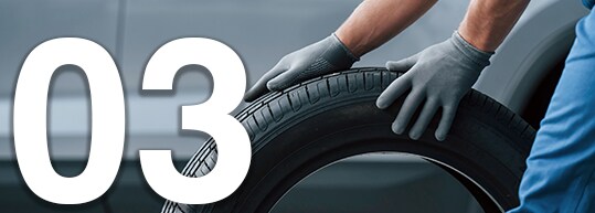 Tips for Spring Cleaning Your Car at Bobby Rahal Acura | 03 Rolling New Tire with Two Hands