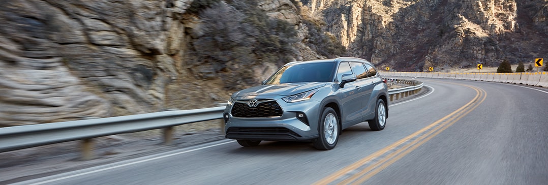 Model Features of the 2021 Toyota Highlander at Bobby Rahal Toyota | Highlander driving on turns inbetween mountains