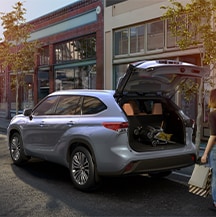 Model Features of the 2021 Toyota Highlander at Bobby Rahal Toyota | Highlander parked infront of stores being loaded with goods