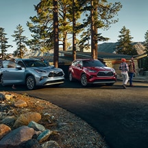 Model Features of the 2021 Toyota Highlander at Bobby Rahal Toyota | Two Highlanders parked ontop of mountain