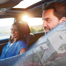 Model Features of the 2021 Toyota Highlander at Bobby Rahal Toyota | Couple go for a drive with windows down