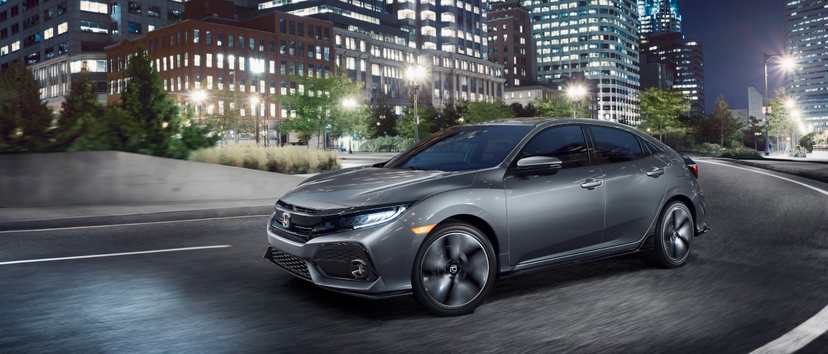 17Civic_Header.jpg Honda Civic driving into the city at night